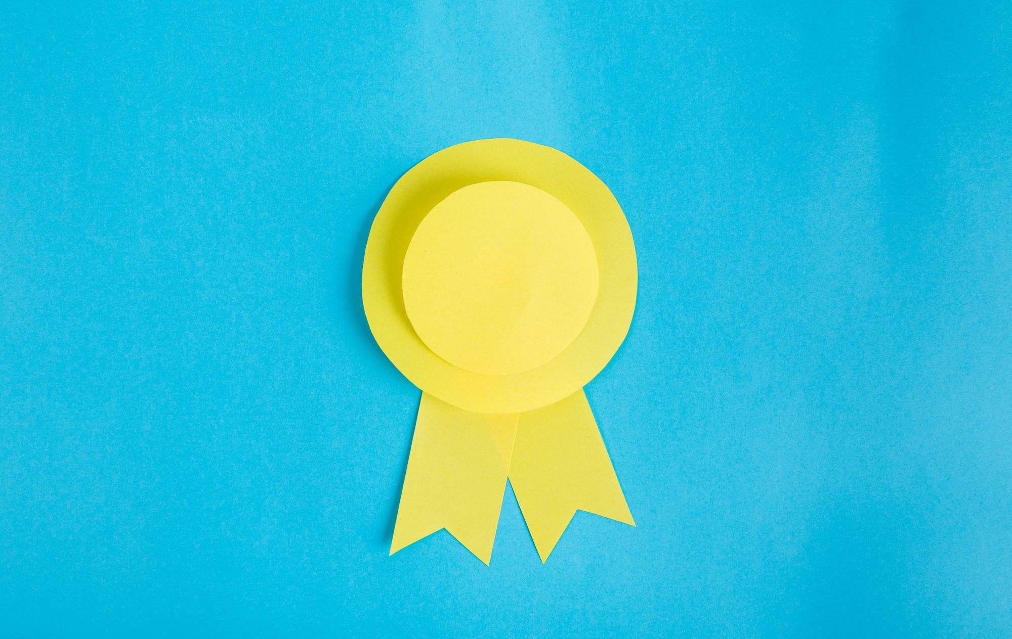 Stock photo of a yellow medal made from paper.