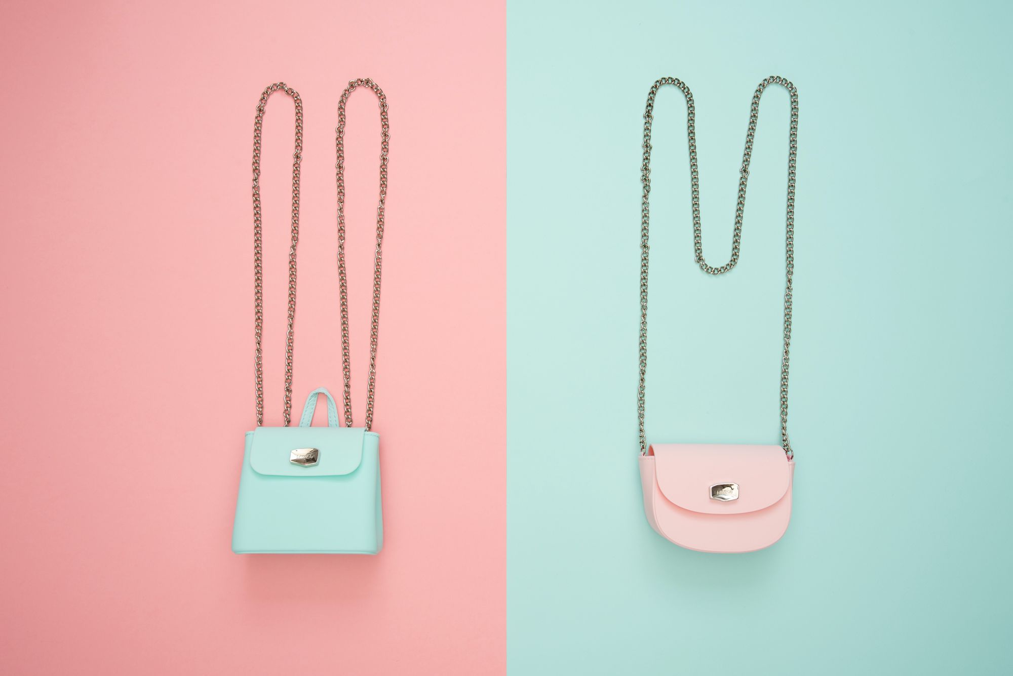 Stock photo of two purses, one pink and one blue.