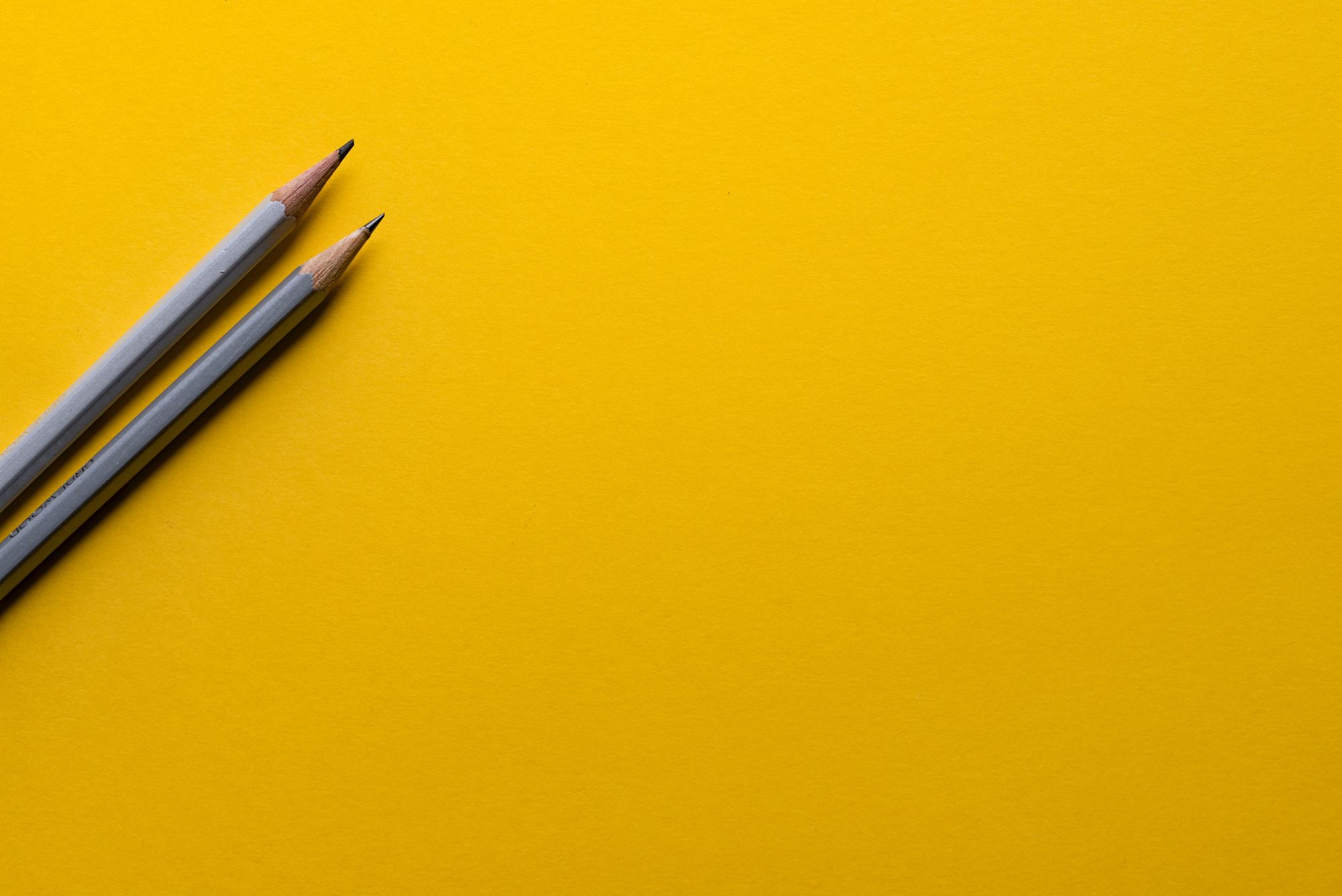 Stock photo of pens on yellow background. 